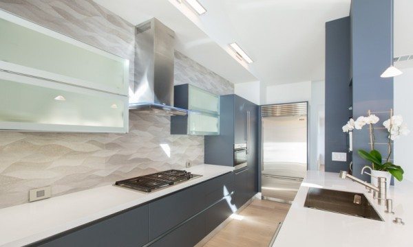 This modern kitchen features cabinets from Aran Cucine: Lower cabinets from the Erika collection in Slate Gray; white frosted glass upper cabinets from the Volare collection.