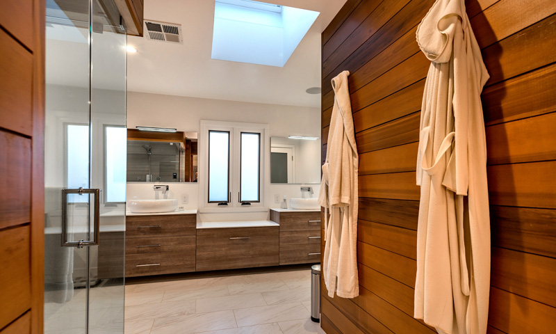 Looking into the master bathroom. Cabinets, mirrors, and LED vanity lighting by BMT Bagni.