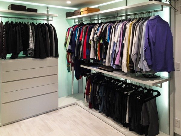 The finished closet has custom designed shelving and hanging rods