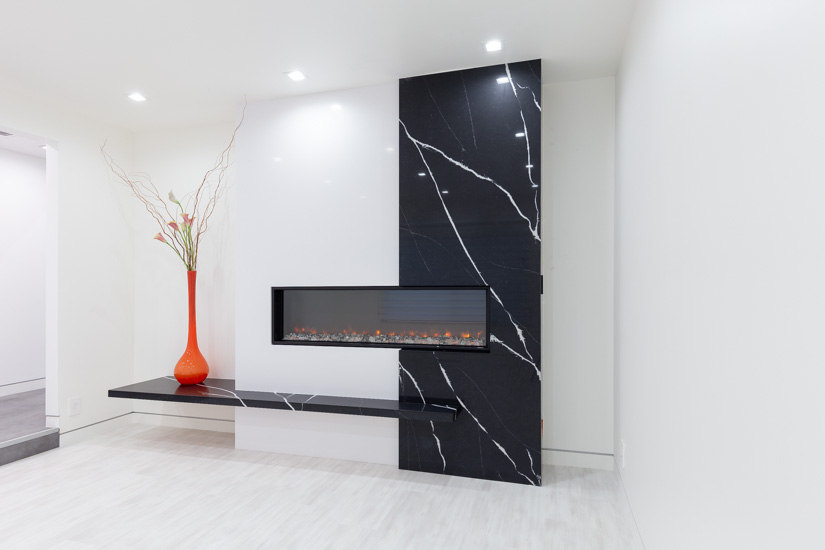 Fireplace feature wall designed with Silestone quartz in Iconic White and Marquina.