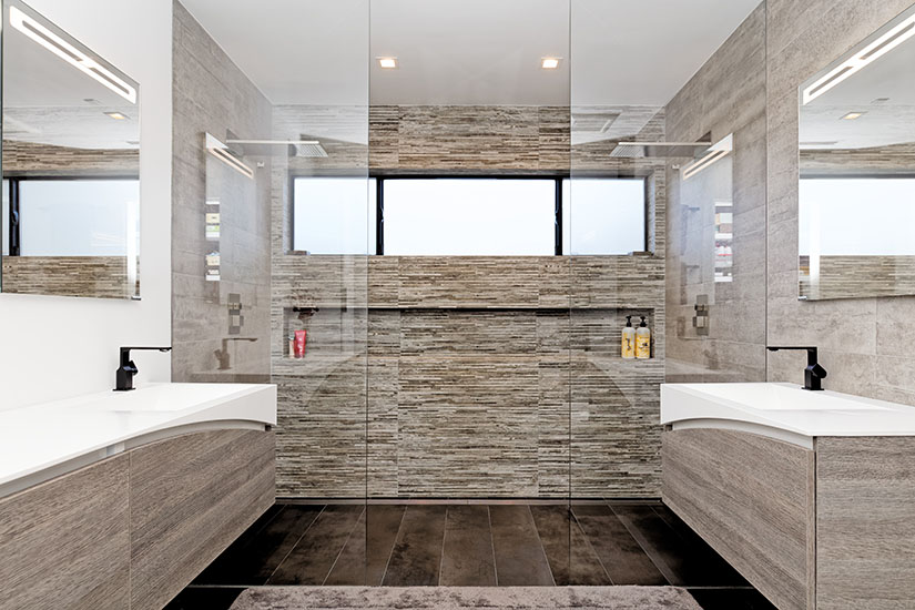 Master bathroom in modern design with two vanities and a large walk-in shower