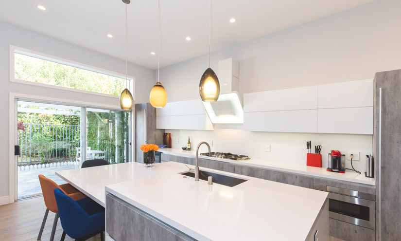 Modern kitchen with large, sliding glass door.