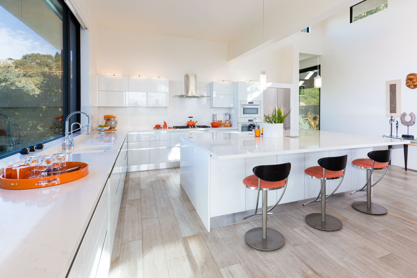 Modern white kitchen with orange accents in Alamo, California