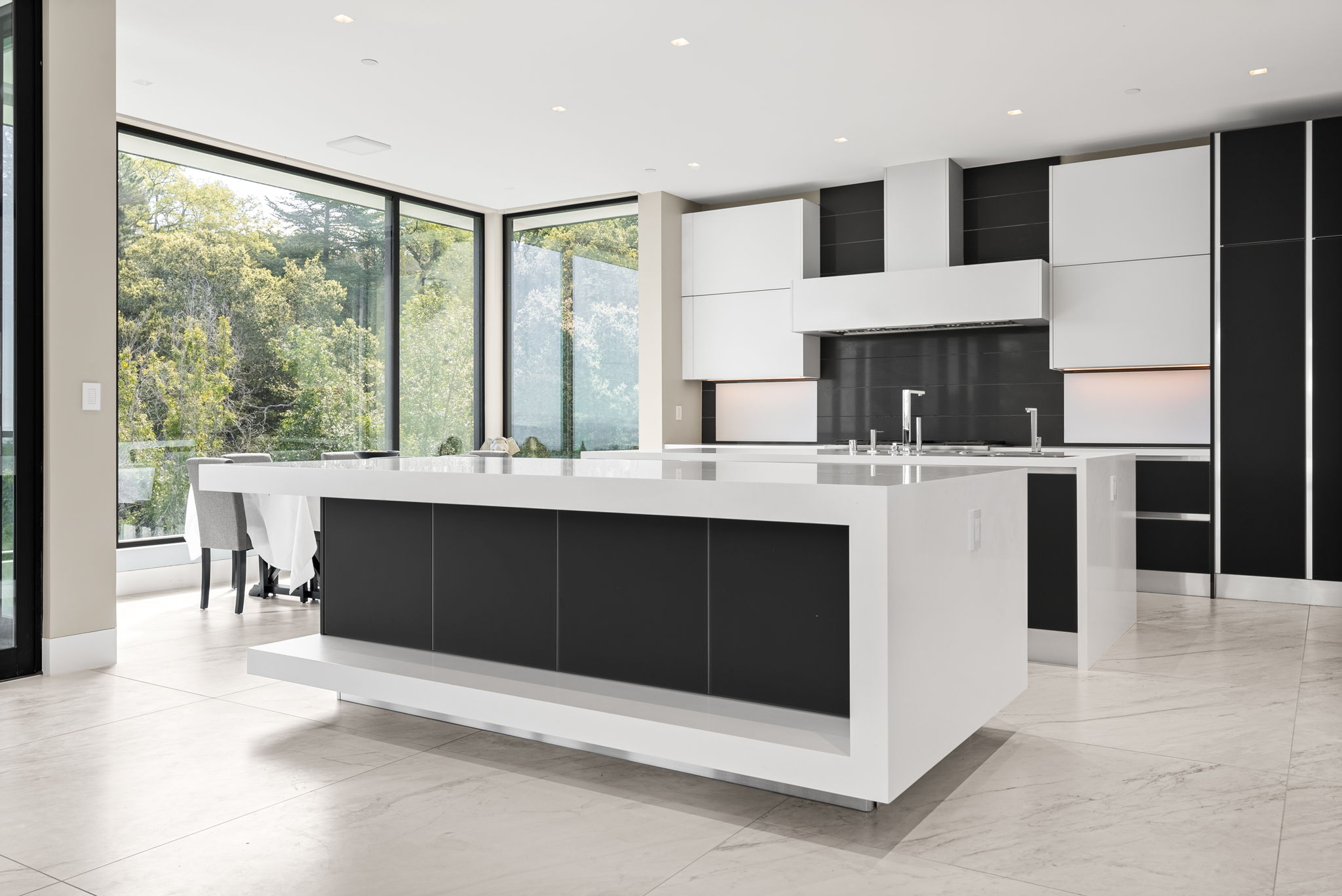 Modern Italian black and white kitchen with a double island.
