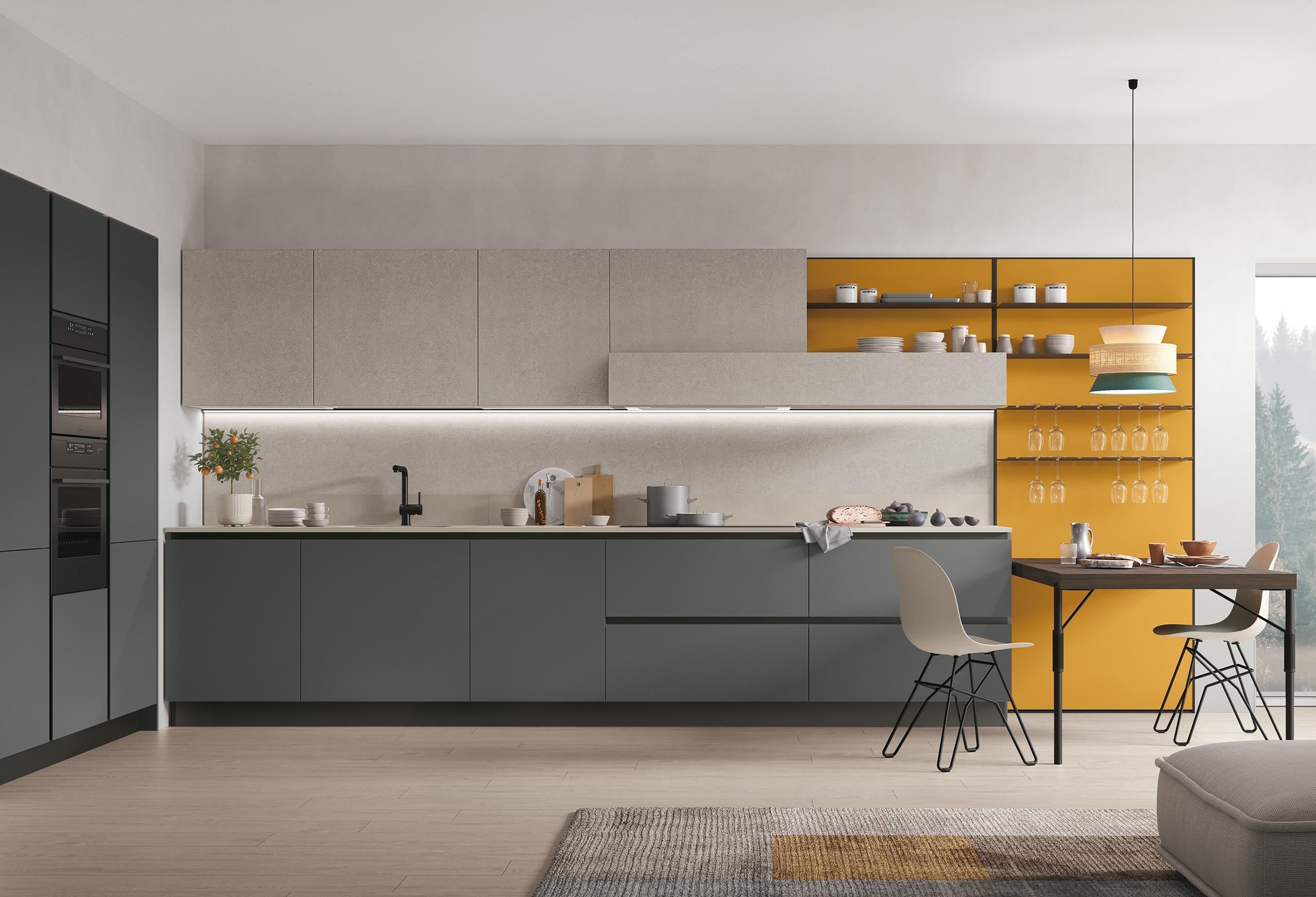 Contemporary Italian kitchen with matte grey cabinetry, neutral upper cabinets, and a mustard yellow shelving feature wall.