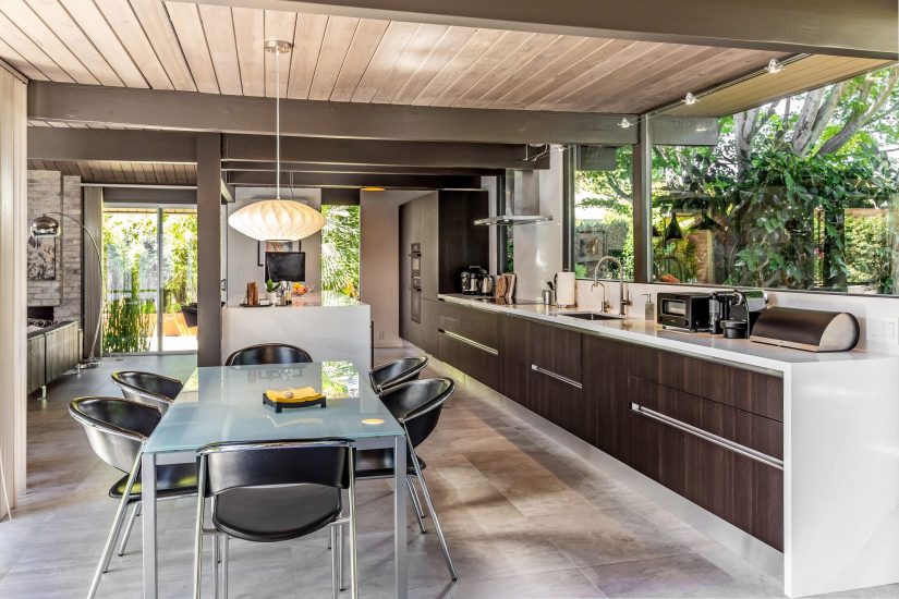 Wine refrigerator integrated into a dark wood island with a white quartz waterfall countertop, Sunnyvale Eichler kitchen